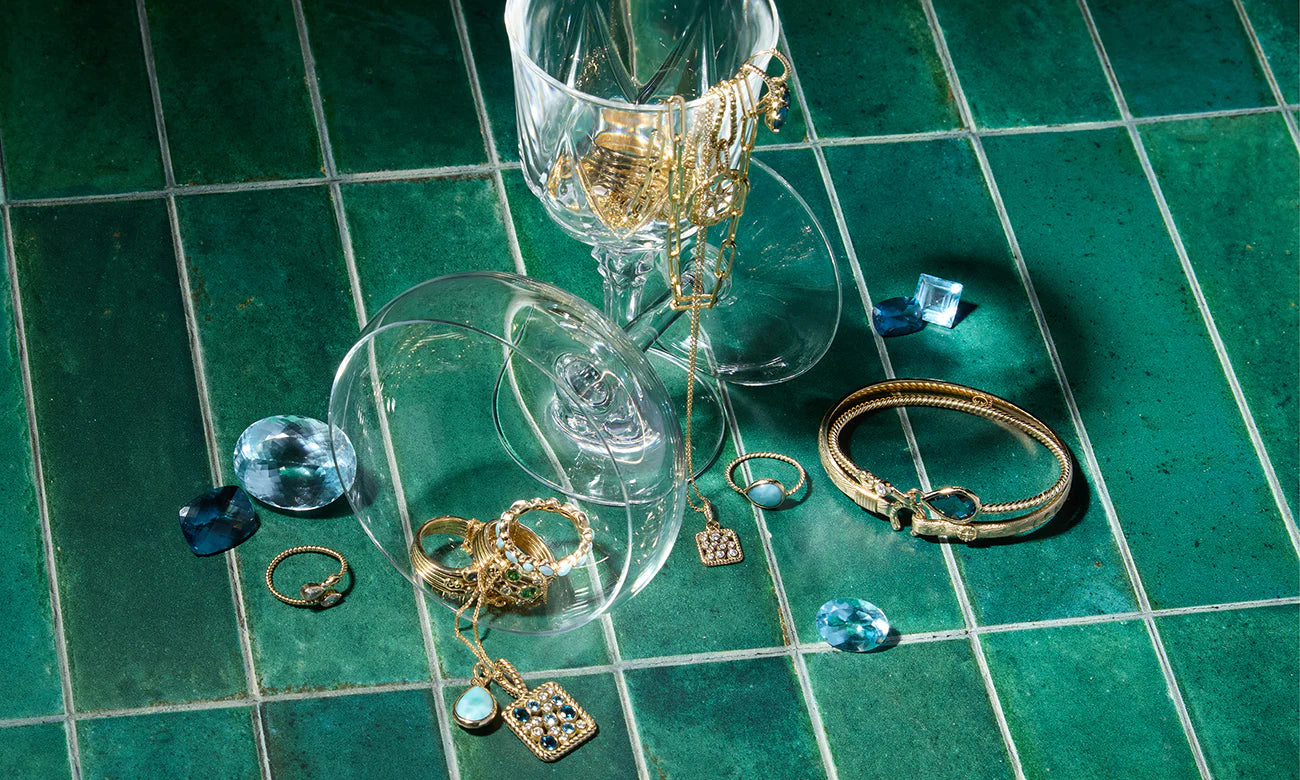 Vibe Jewelry in wine glasses on green tile